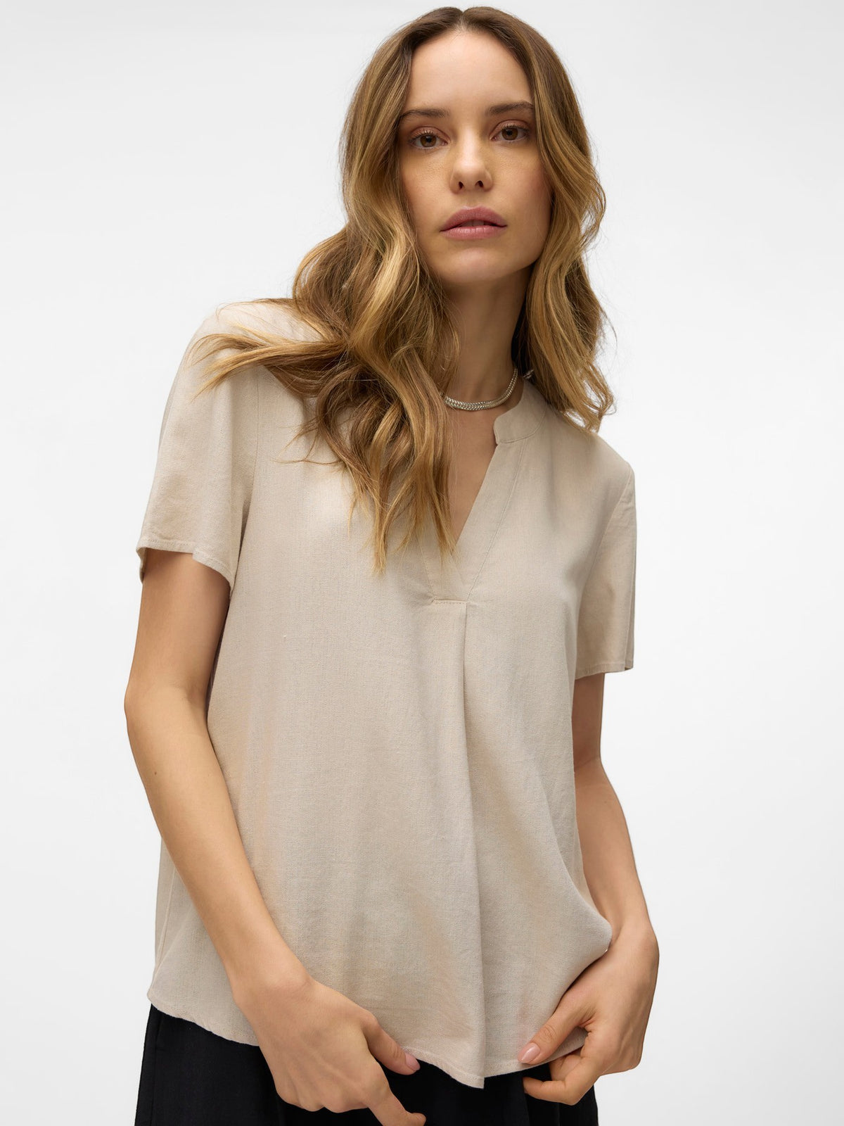 Antique Rose Boutique beige linen mix V-neck blouse with short sleeves worn by a model