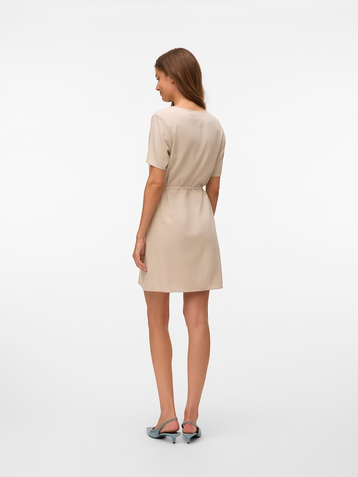 Antique Rose Boutique beige linen-mix short sleeve dress with a tie-waist, shown from the back on a model.