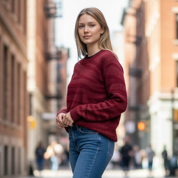 Antique Rose Boutique burgundy chunky knit jumper with round neck and animal print pattern worn by a woman outdoors.
