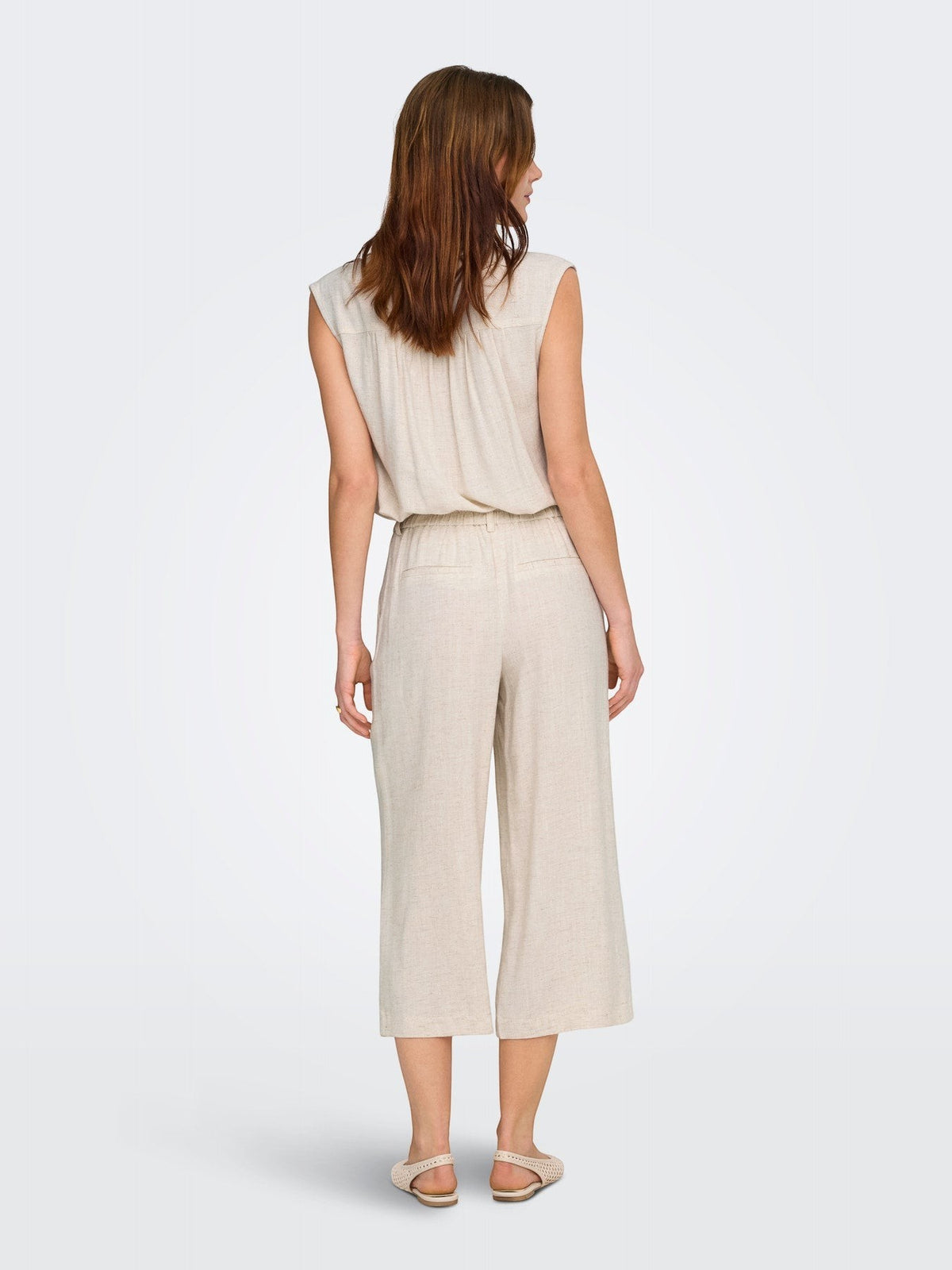 Antique Rose Boutique cream linen mix culotte trousers with wide legs and belt loops, back view on a model.