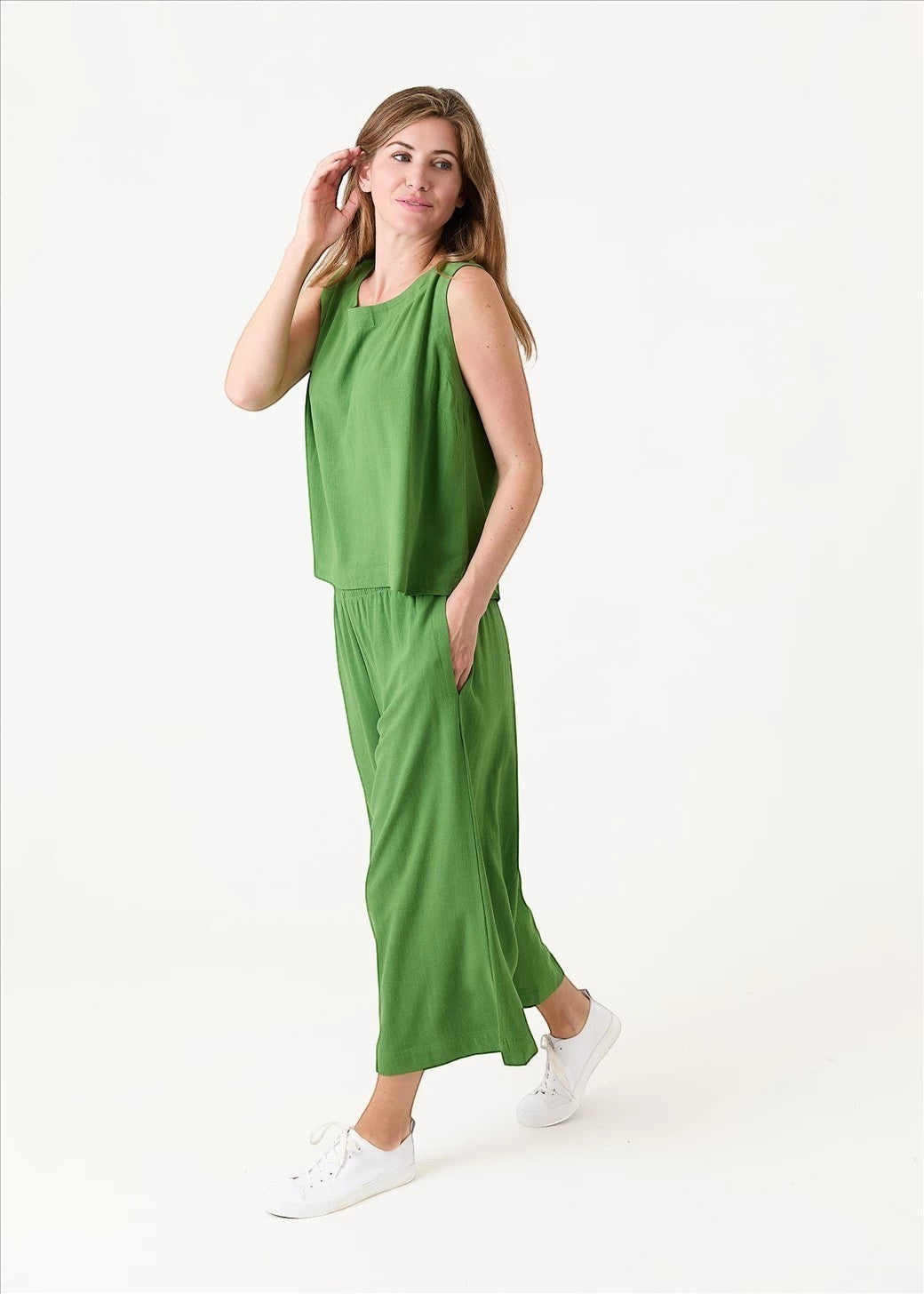 Antique Rose Boutique green linen viscose wide-leg culottes and matching sleeveless top worn by a woman with sneakers.