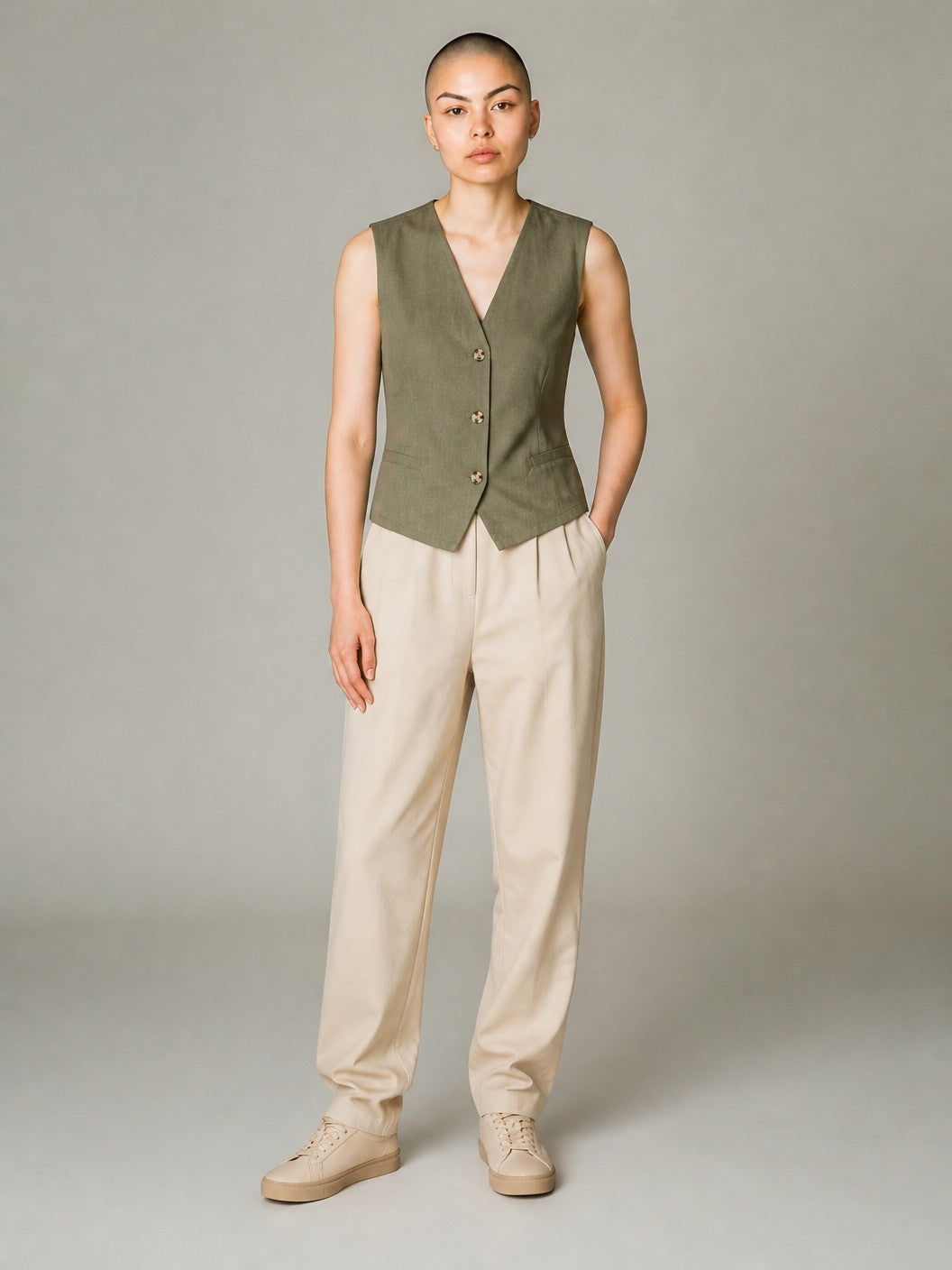 Antique Rose Boutique deep lichen green cotton and linen waistcoat with button fastening worn by a model
