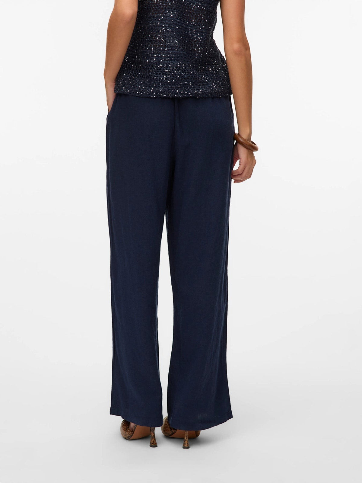 Antique Rose Boutique navy blue wide-leg linen mix trousers with an elasticated waist, back view.