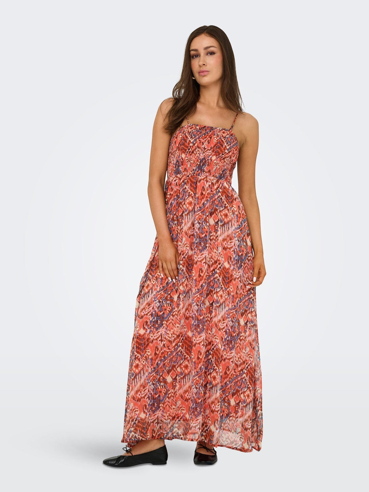 Antique Rose Boutique orange sleeveless maxi dress with V-neck, smock detail, and patterned woven fabric on a model