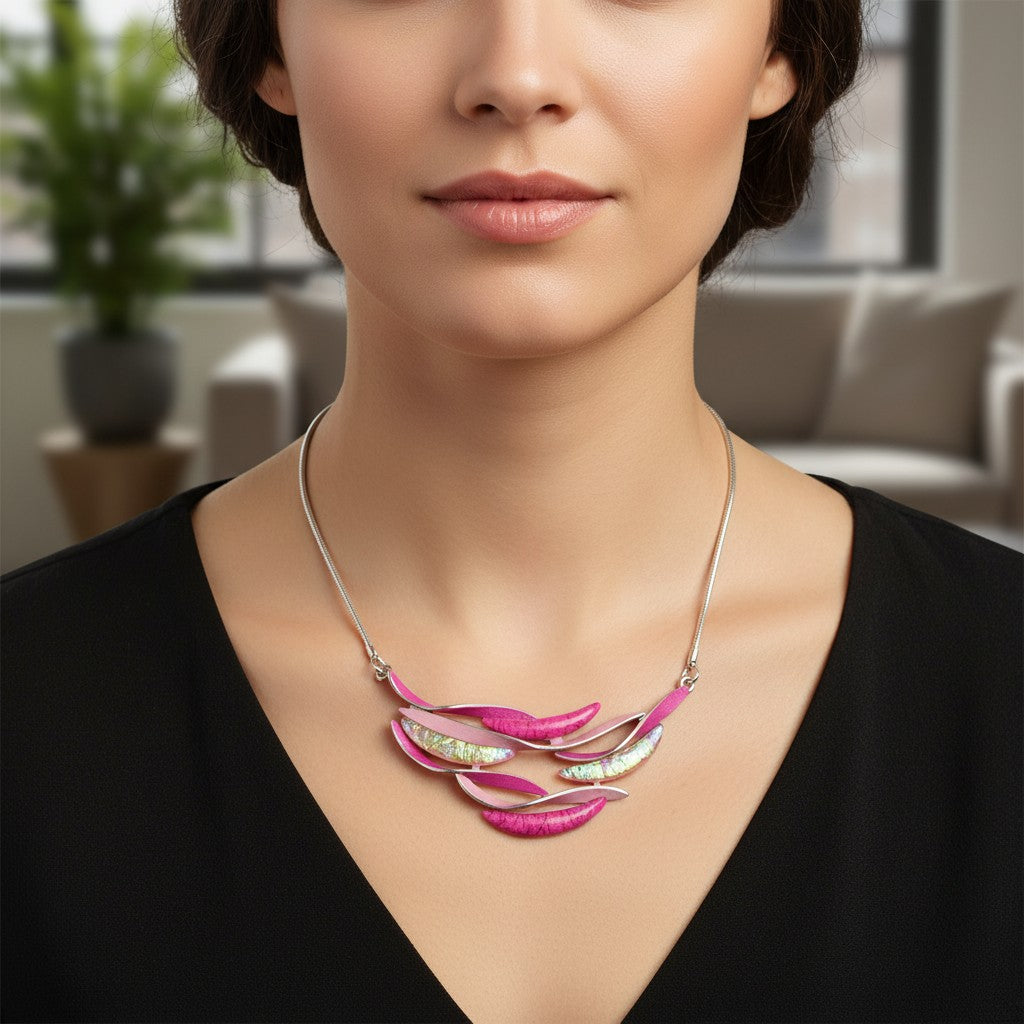 Antique Rose Boutique short adjustable pink resin wave necklace worn by a model in a black top