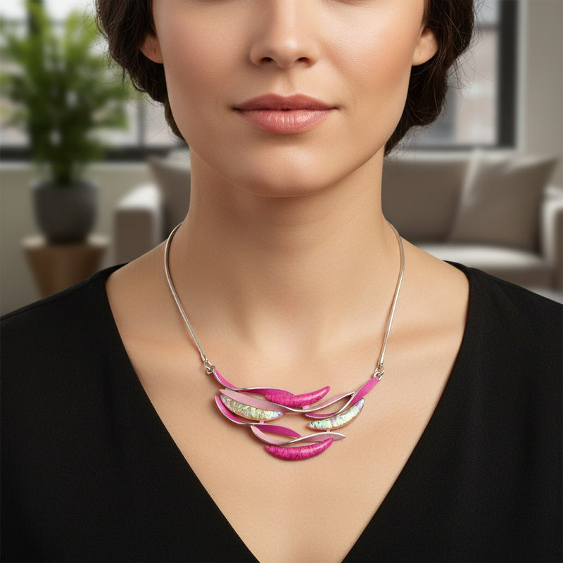 Antique Rose Boutique short adjustable pink resin wave necklace worn by a model in a black top