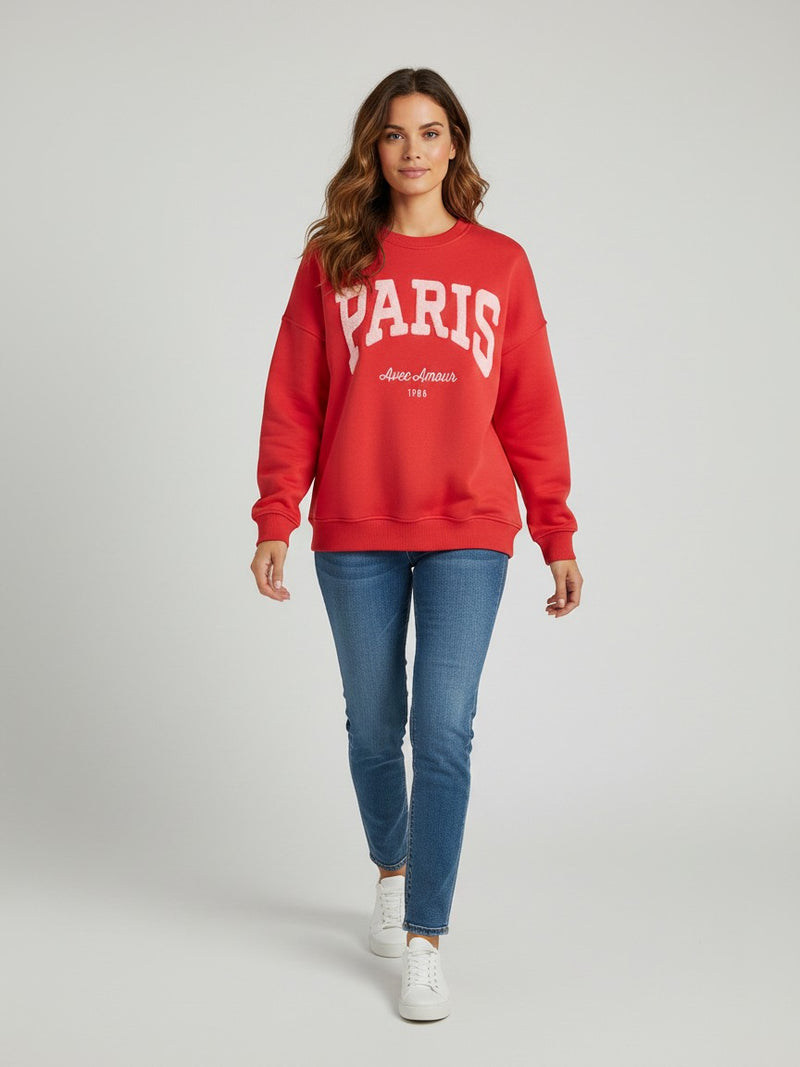 Antique Rose Boutique red long sleeve sweatshirt with Paris embroidery worn by a woman with blue jeans and sneakers