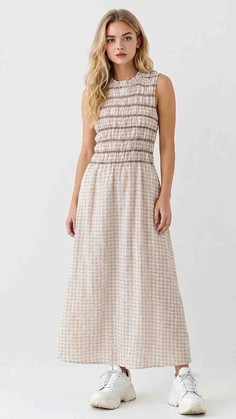 Antique Rose Boutique sleeveless maxi dress with a smocked bodice and beige gingham print worn with white sneakers.