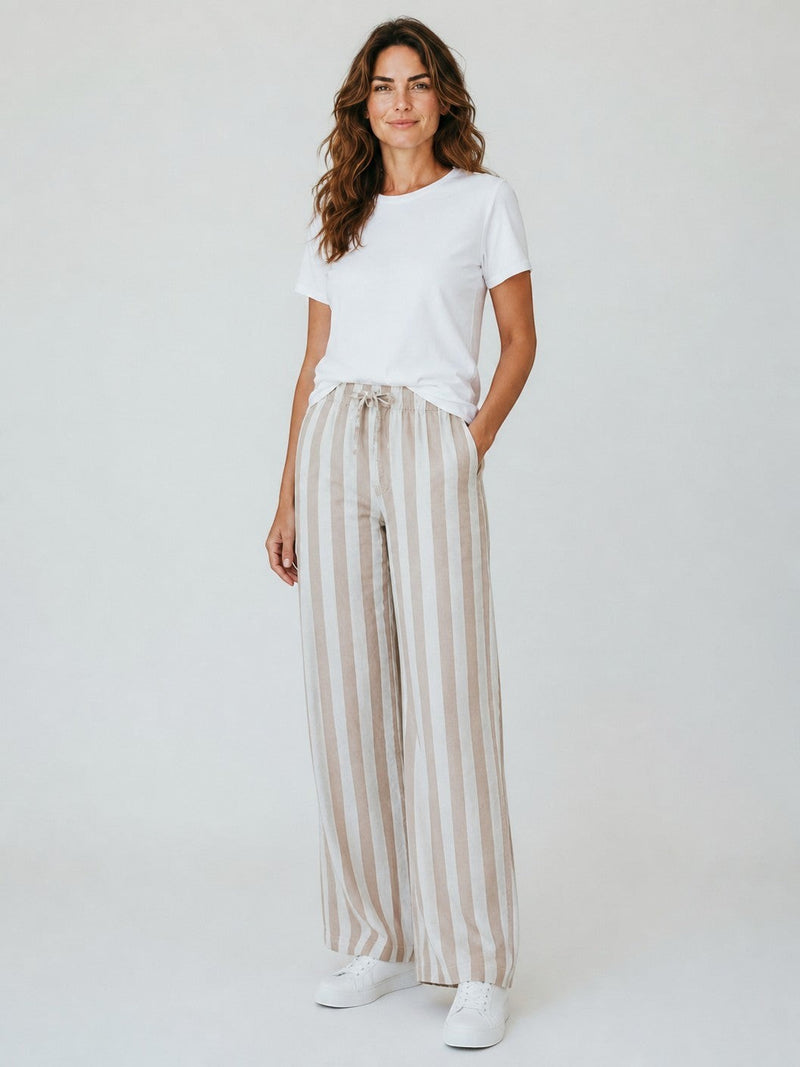 Antique Rose Boutique striped linen wide-leg trousers with drawstring waist worn by a woman with a white t-shirt