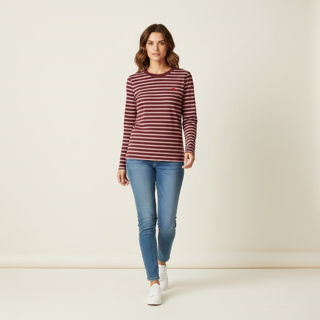 Antique Rose Boutique model wearing a wine and white striped organic cotton long sleeve t-shirt with a heart logo.