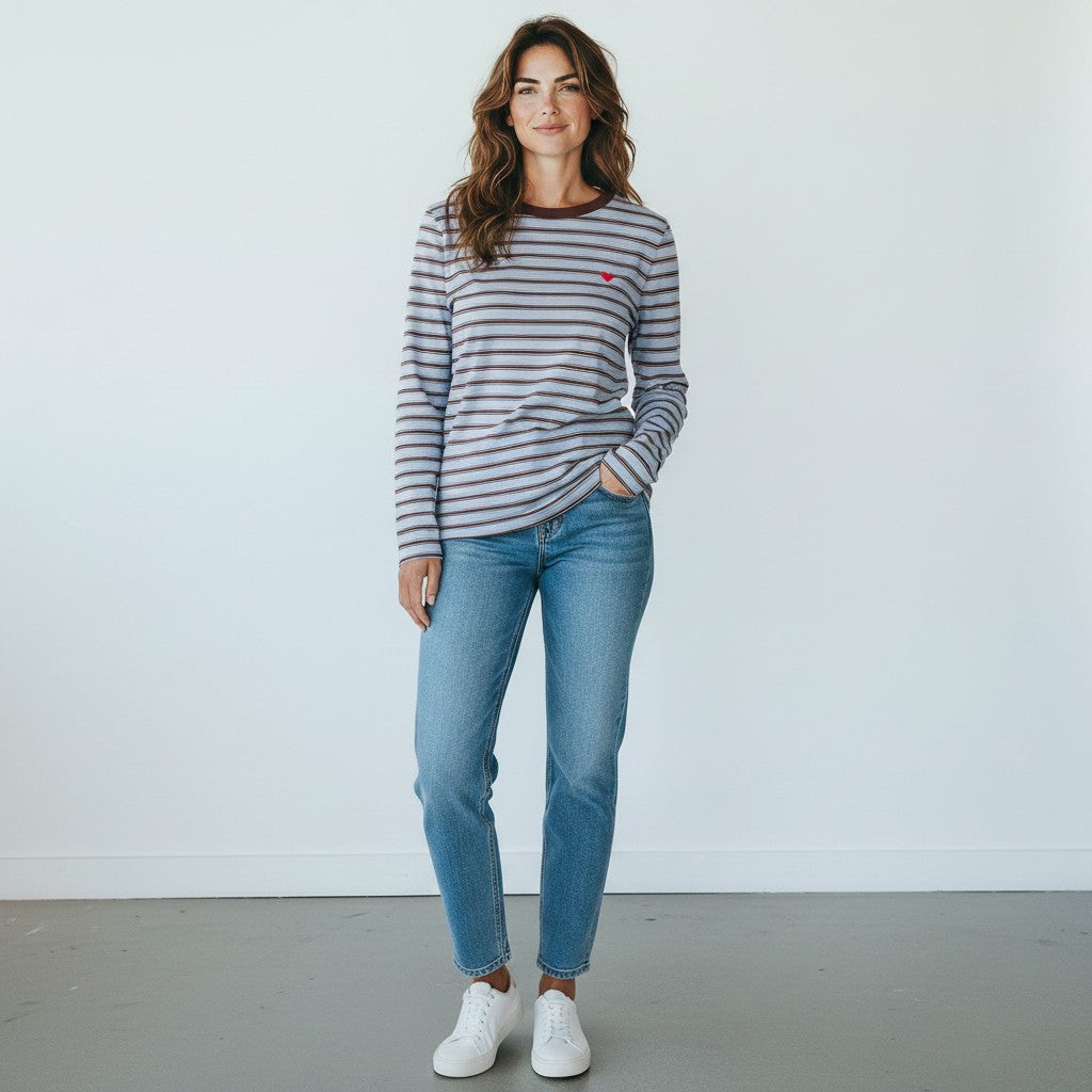 Antique Rose Boutique model wearing a blue striped organic cotton long sleeve round neck t-shirt with a heart logo