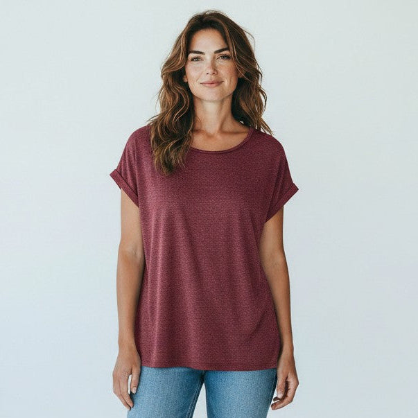 Antique Rose Boutique syrah red loose fit viscose t-shirt with gold glitter stripes worn by a woman with blue jeans