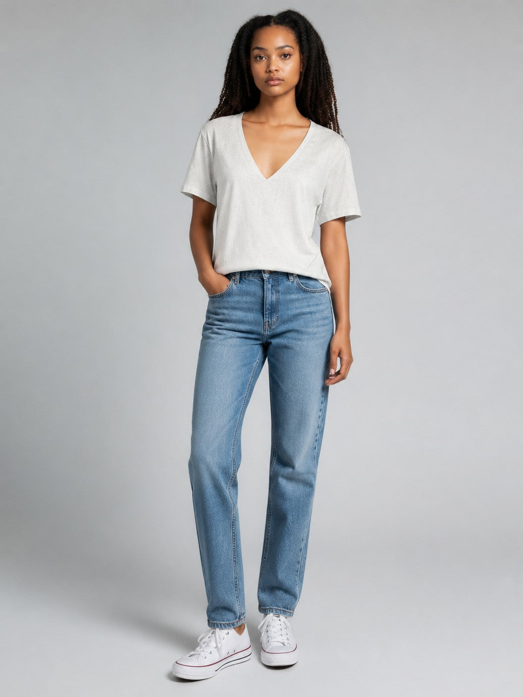 Antique Rose Boutique white linen mix V-neck T-shirt worn by a model with blue jeans and white sneakers