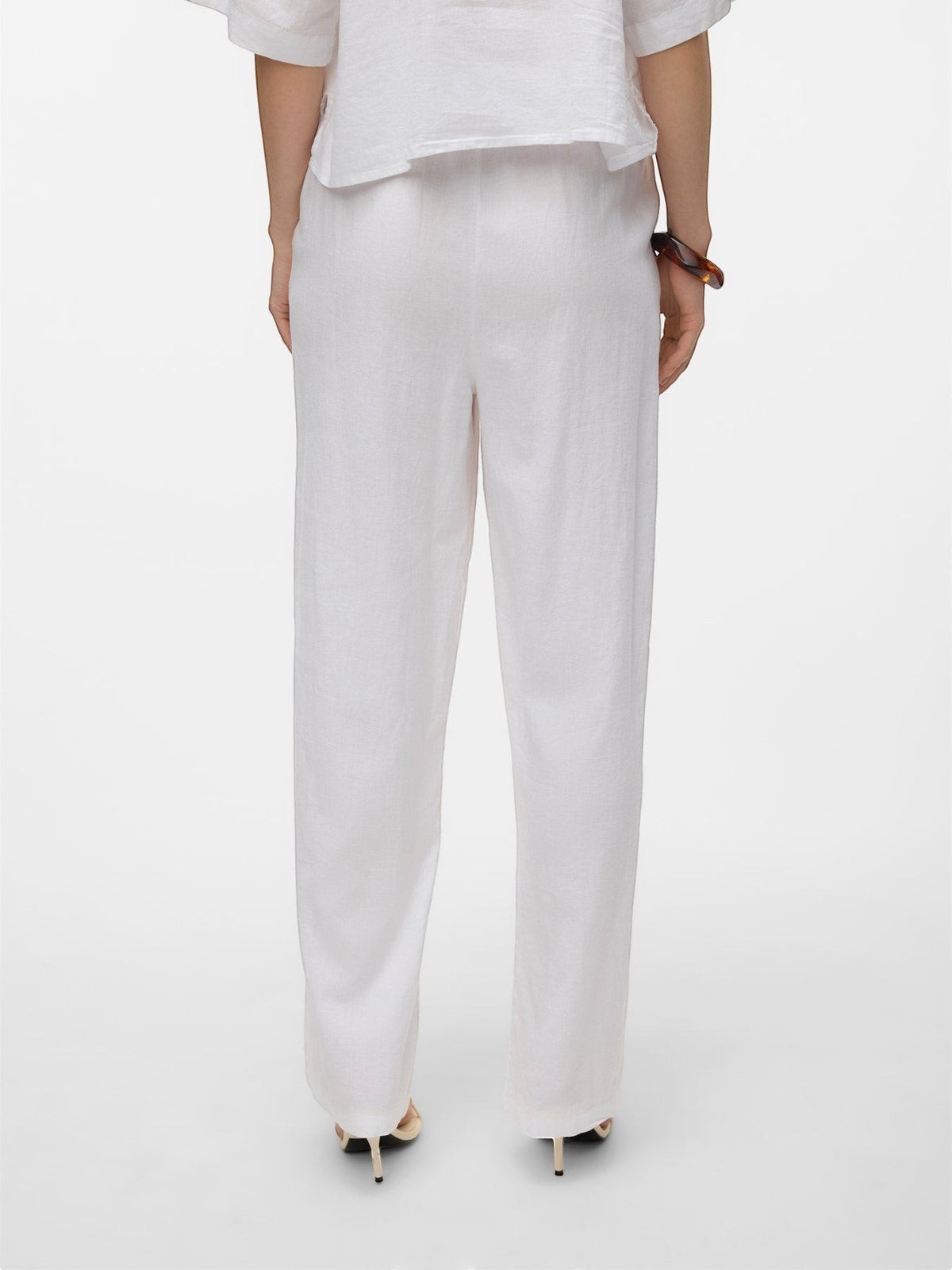 Antique Rose Boutique Vero Moda white linen wide-leg trousers viewed from the back with a drawstring waist